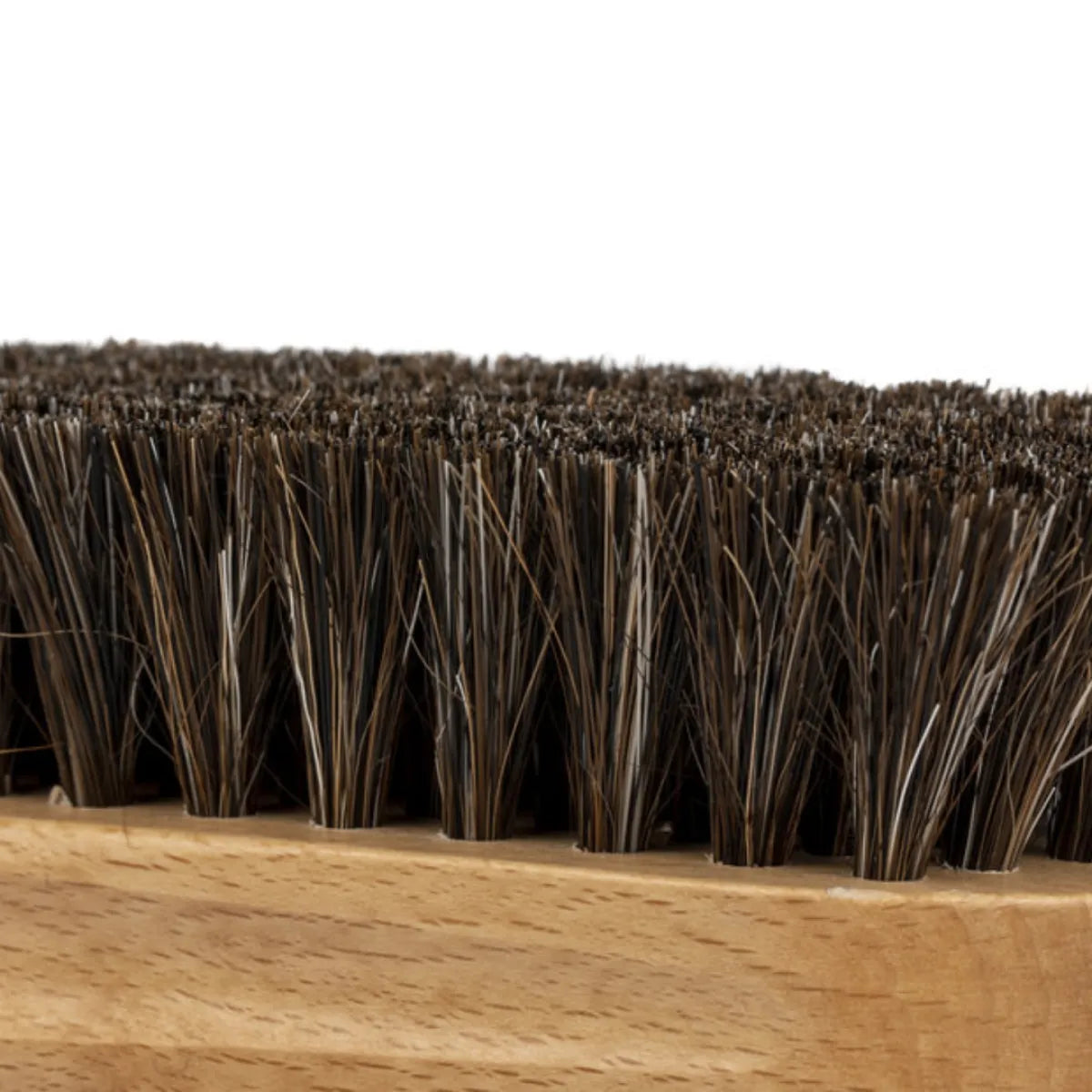 Close-up of stiff, dark bristles on the Leather Cleaning Brush, emphasizing its detailed texture and sturdy wooden base.