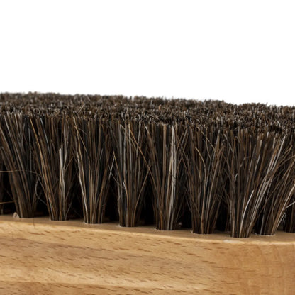 Close-up of stiff, dark bristles on the Leather Cleaning Brush, emphasizing its detailed texture and sturdy wooden base.