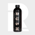 A black bottle labeled "1+1 GRATIS Marine Attack" with metallic letters and patterns stands upright. The label states: kalkanslag verwijderen en boot reinigen, biologisch afbreekbaar. A large faded R appears in the light gray background.