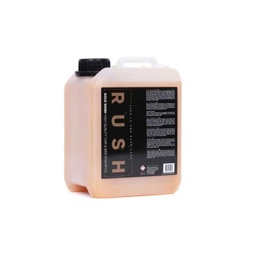 A 2.5-liter plastic container with a black cap and handle, labeled Gold Wash 2,5 liter. The container holds an orange liquid and displays product details in white text on a black label.