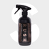 A black spray bottle labeled "Leather Matt Clean" with a geometric pattern sits on a light gray background featuring a large faded dollar sign—ideal for cleaning lederen autobekleding and achieving a matte finish.